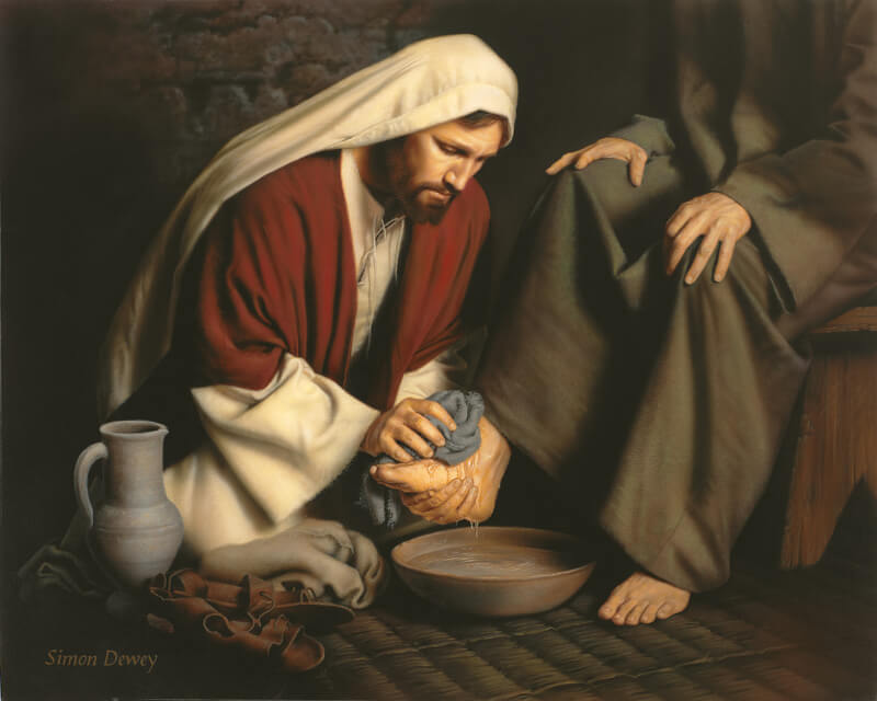 Jesus washing the feet of a man with a cloth and a pan